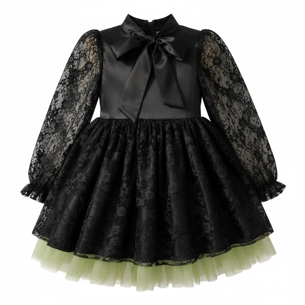 Sea Dragon Dreams girls' black satin witch dress with lace sleeves, bow neckline, and green tulle hem for Halloween.