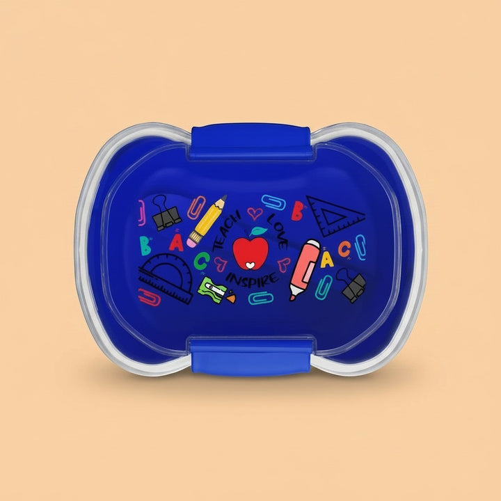 Sea Dragon Dreams Teach Love Inspire two-tier blue bento box with school supply graphics on a light background