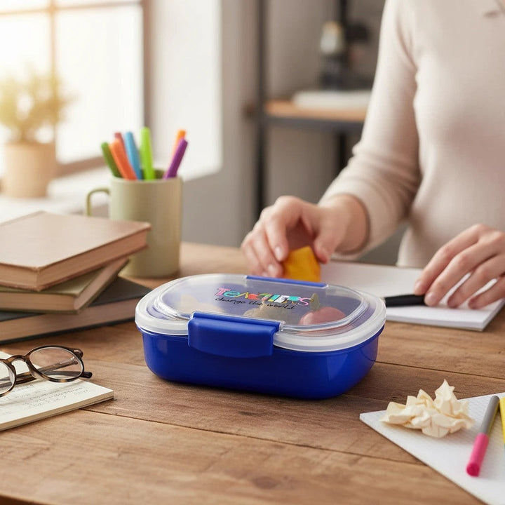 Sea Dragon Dreams Teachers Change The World blue two-tier bento box on a wooden desk with books and stationery