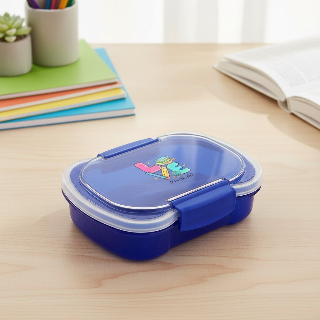 Sea Dragon Dreams blue two-tier bento box with Love Teacher's Life graphic on a wooden desk with notebooks.