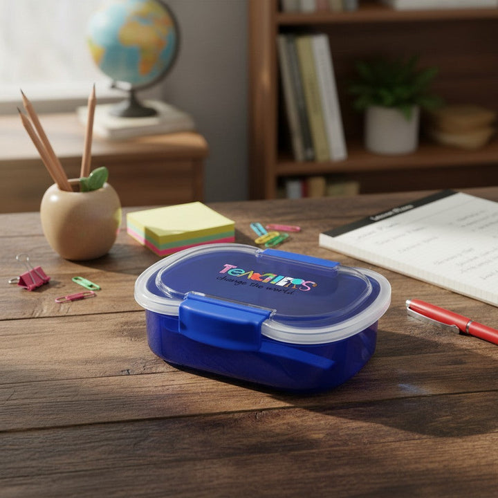 Sea Dragon Dreams blue two-tier bento box with Teachers Change The World text on a wooden desk with school supplies.