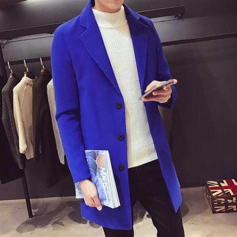 Sea Dragon Dreams men's royal blue cotton trench coat with a turn-down collar, worn over a white turtleneck sweater.