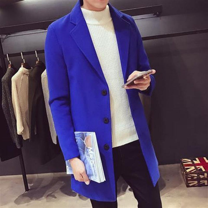 Sea Dragon Dreams men's royal blue cotton trench coat with a turn-down collar, worn over a white turtleneck sweater.