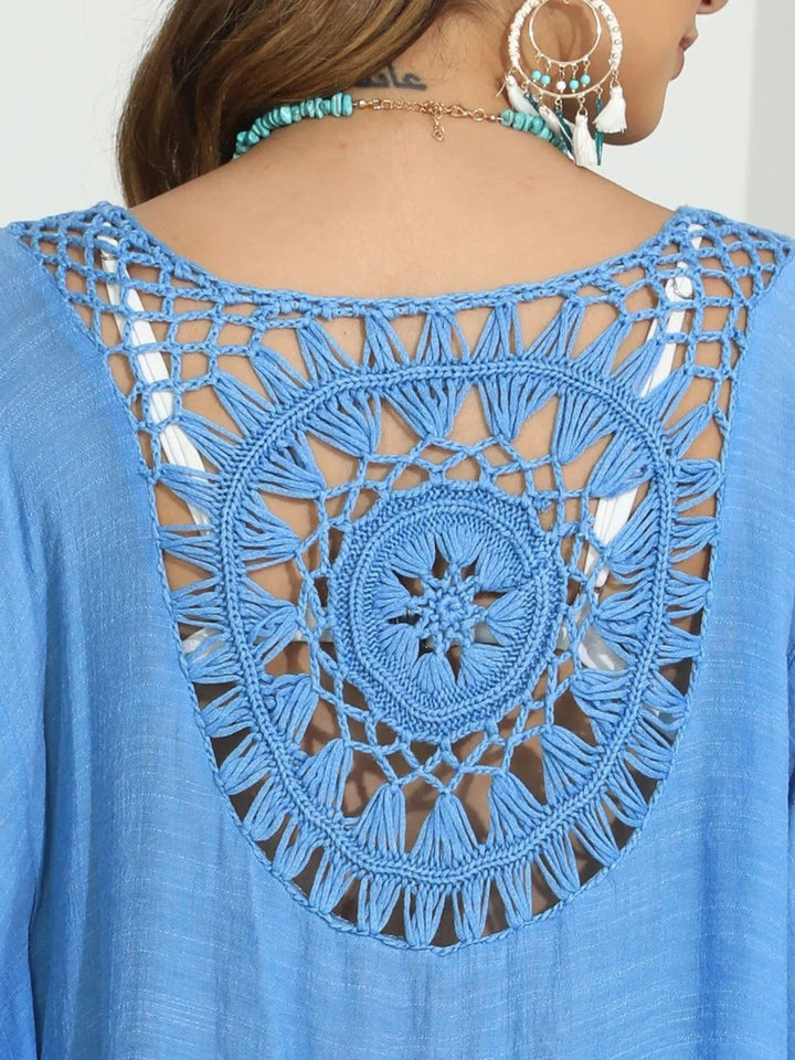 Sea Dragon Dreams blue crochet cover-up with intricate round back cutout detail and boho tassel trim
