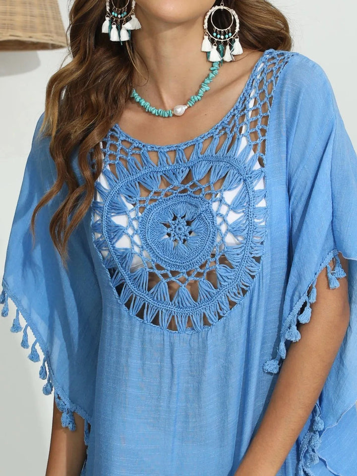 Sea Dragon Dreams blue crochet beach cover-up with round neck, intricate openwork, and playful tassel hem details.