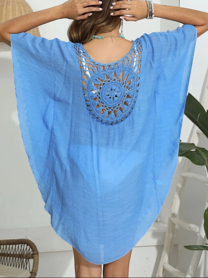 Sea Dragon Dreams blue crochet cover-up with a round neck, openwork back detail, and tassel hem for beach wear.