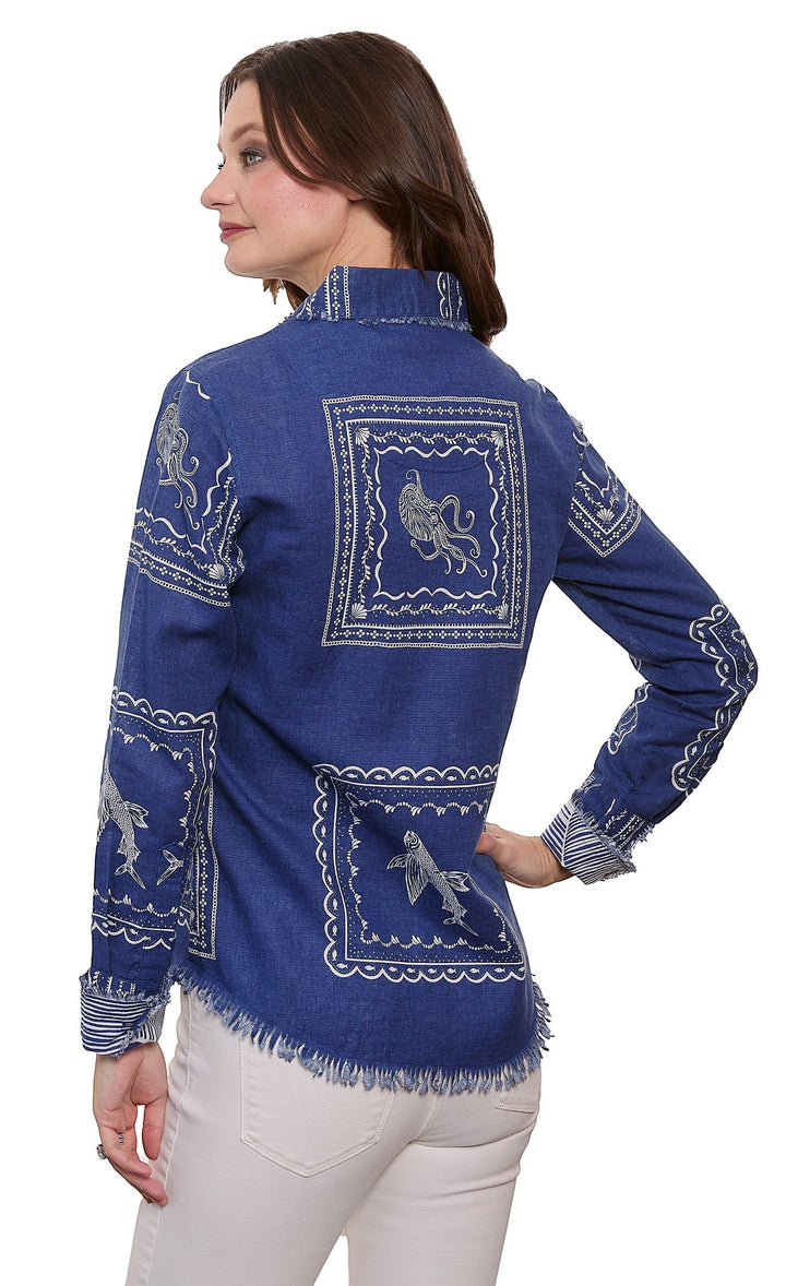 Sea Dragon Dreams blue denim blouse with white nautical sealife print, frayed hem, and long sleeves on a model.
