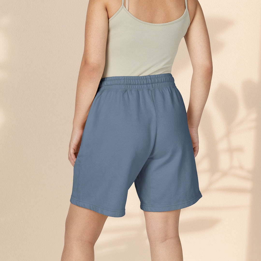 Model wearing Sea Dragon Dreams blue lightweight fleece sweat shorts with an elastic waistband, back view.