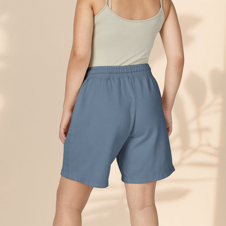 Model wearing Sea Dragon Dreams blue lightweight fleece sweat shorts with an elastic waistband, back view.
