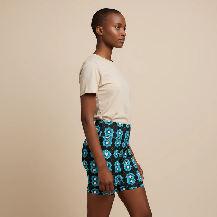 Sea Dragon Dreams women's workout shorts featuring a blue floral pattern, worn by a model in a side profile view.