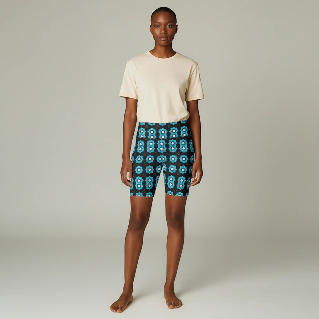 Model wearing Sea Dragon Dreams blue floral workout shorts with a beige t-shirt for an active lifestyle