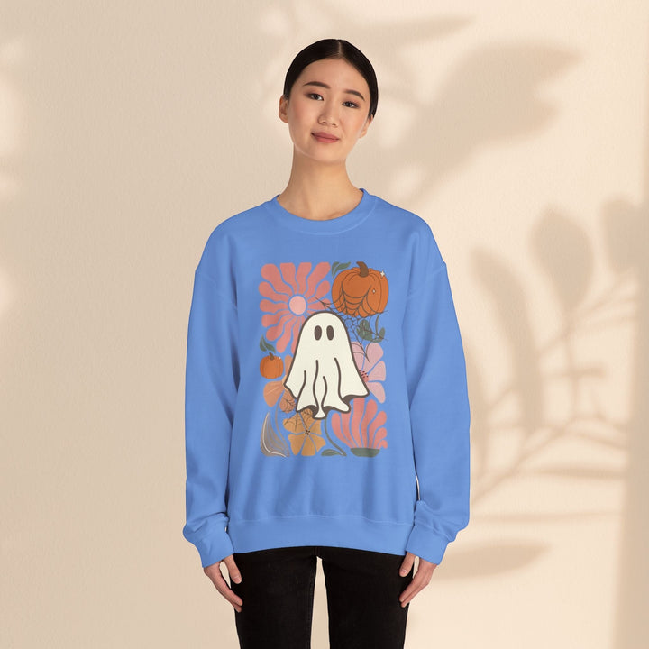 Sea Dragon Dreams blue crewneck sweatshirt with a retro ghost and pumpkin graphic print worn by a woman