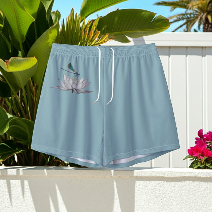 Sea Dragon Dreams men's light blue swim shorts featuring a delicate dragonfly and lotus flower print.