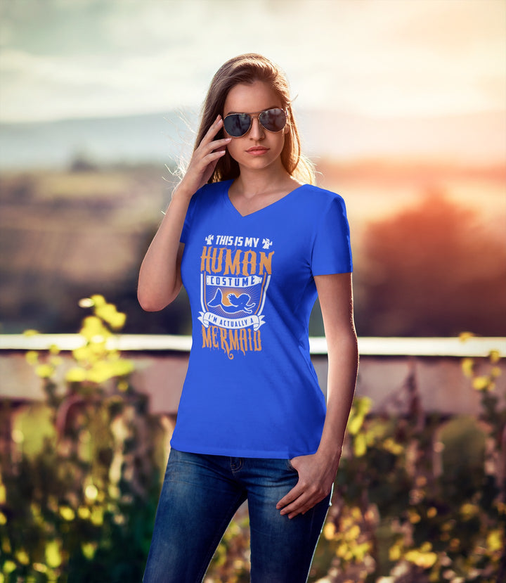 Sea Dragon Dreams unisex blue V-neck tee with a white and orange Human Mermaid graphic, worn by a woman in sunglasses.