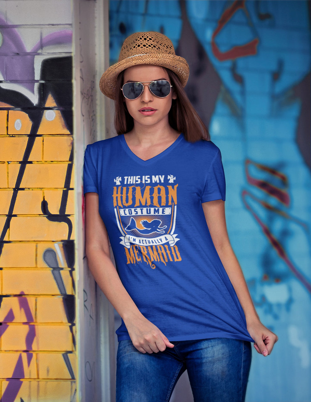 Sea Dragon Dreams unisex blue V-neck tee with Human Mermaid graphic, worn by a woman with a straw hat and sunglasses.