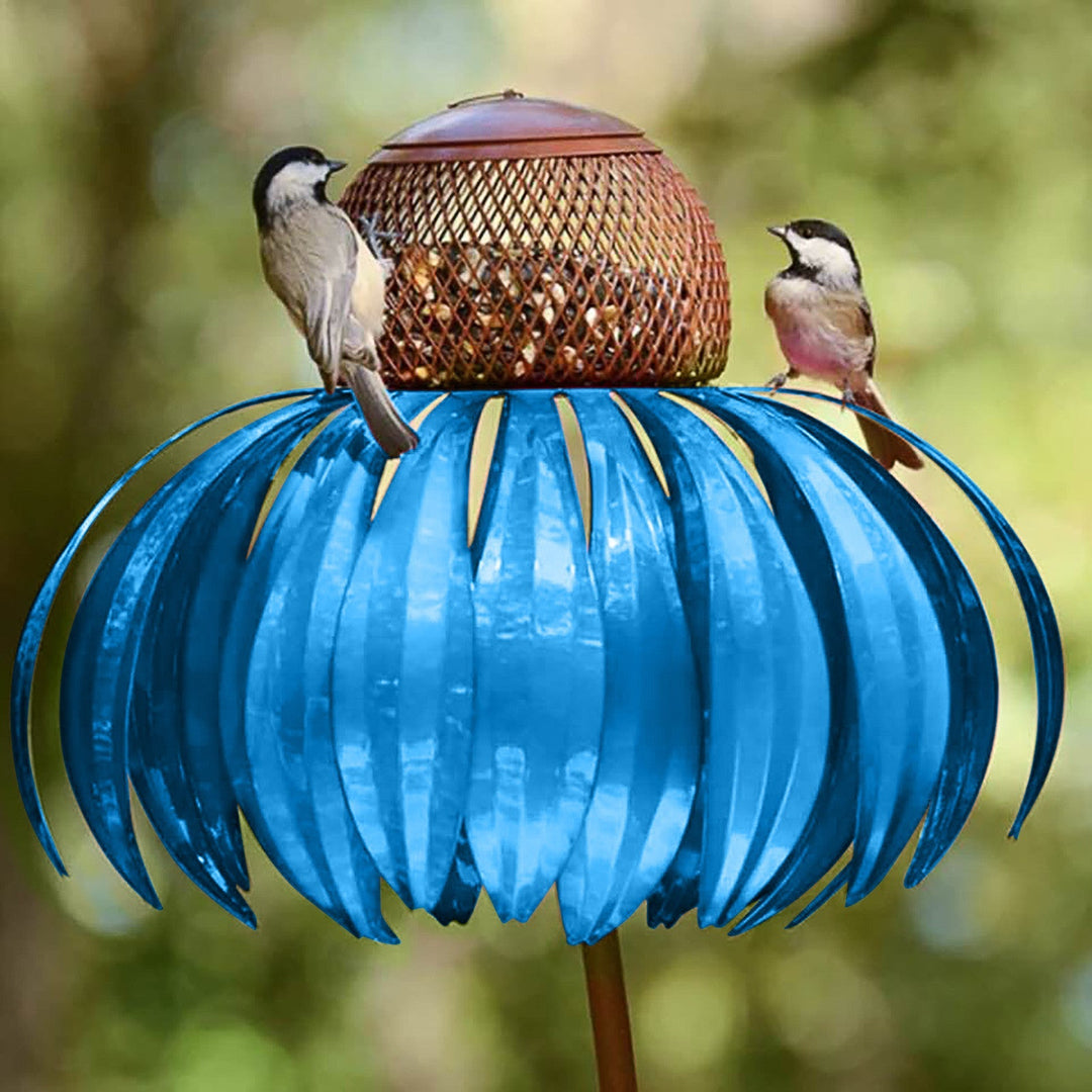 Sea Dragon Dreams blue metal petal-shaped bird feeder with two songbirds perched on top in a garden setting