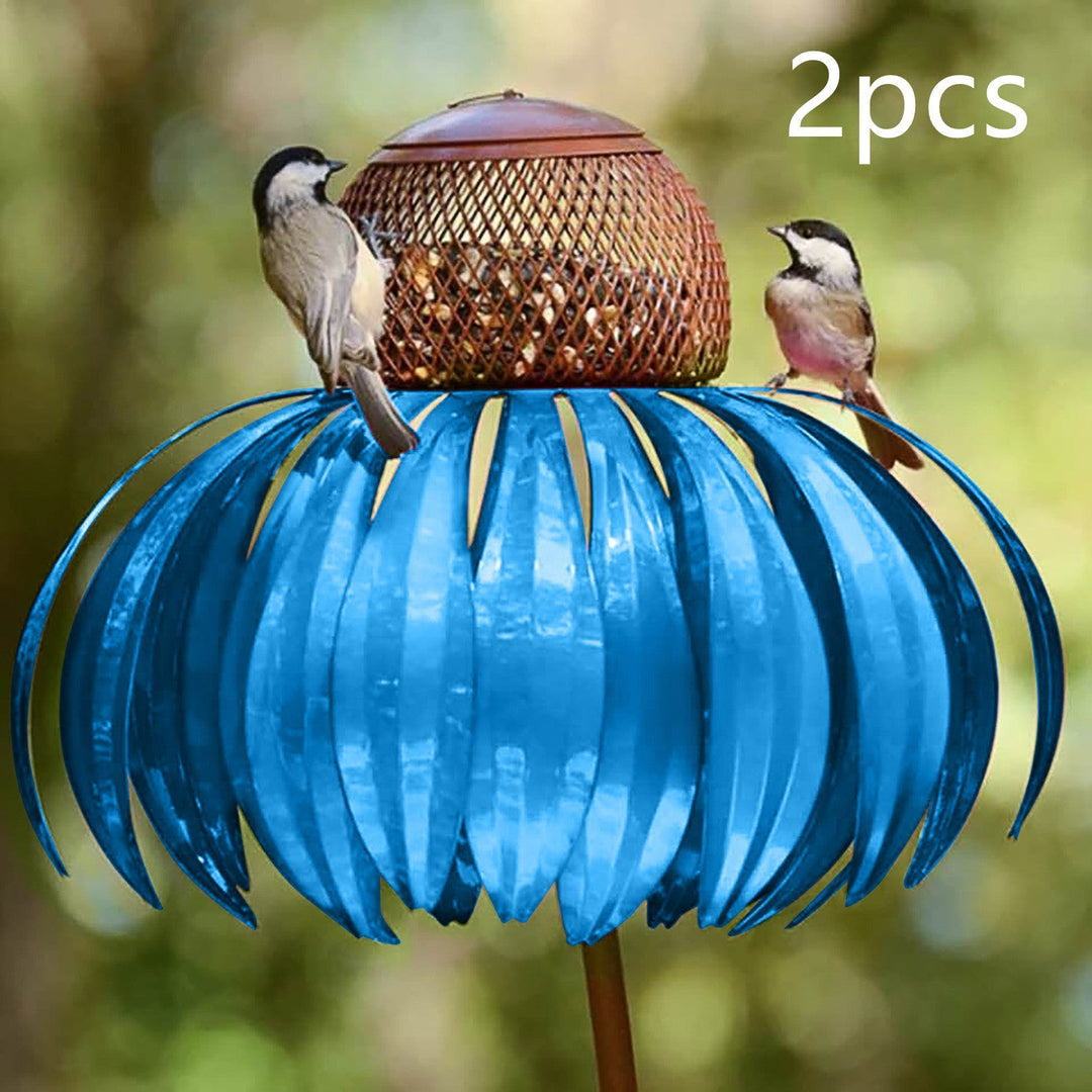 Sea Dragon Dreams blue metal petal-shaped bird feeder with two small birds perched on top in a garden setting