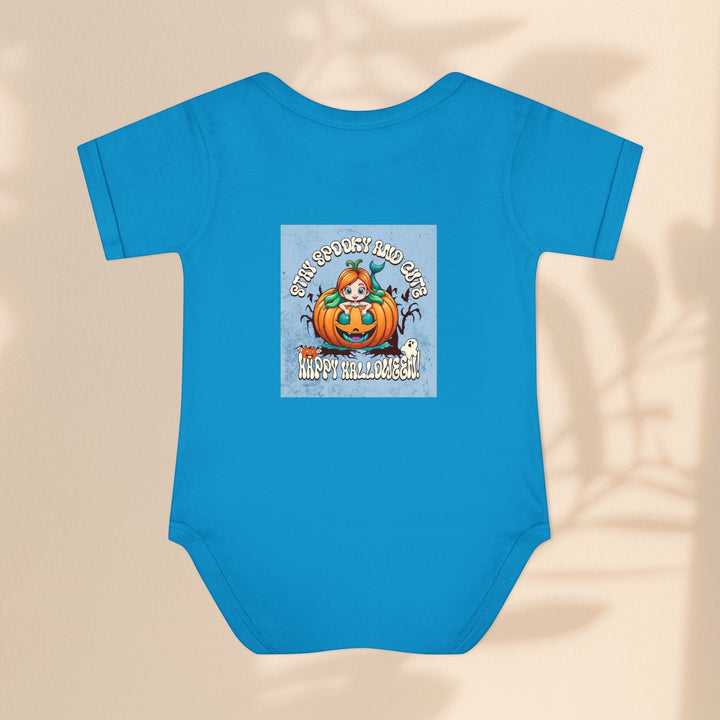 Sea Dragon Dreams infant bodysuit in blue cotton with a Stay Spooky and Cute pumpkin Halloween graphic print