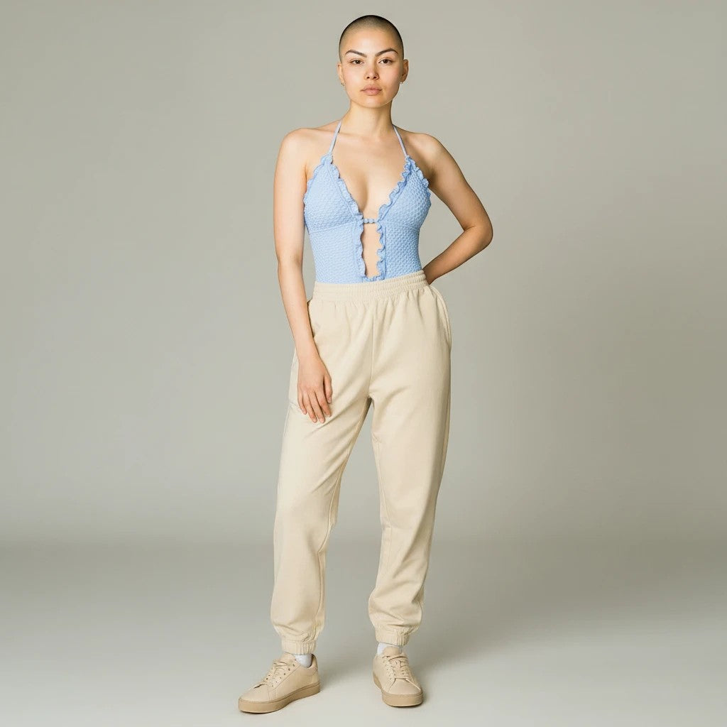 Model wearing a Sea Dragon Dreams light blue textured push-up bikini top with ruffle trim and lace-up front detail.