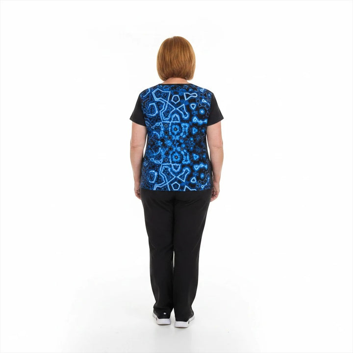 Sea Dragon Dreams women's sports jersey with a blue geometric pattern, back view on a model wearing black trousers.