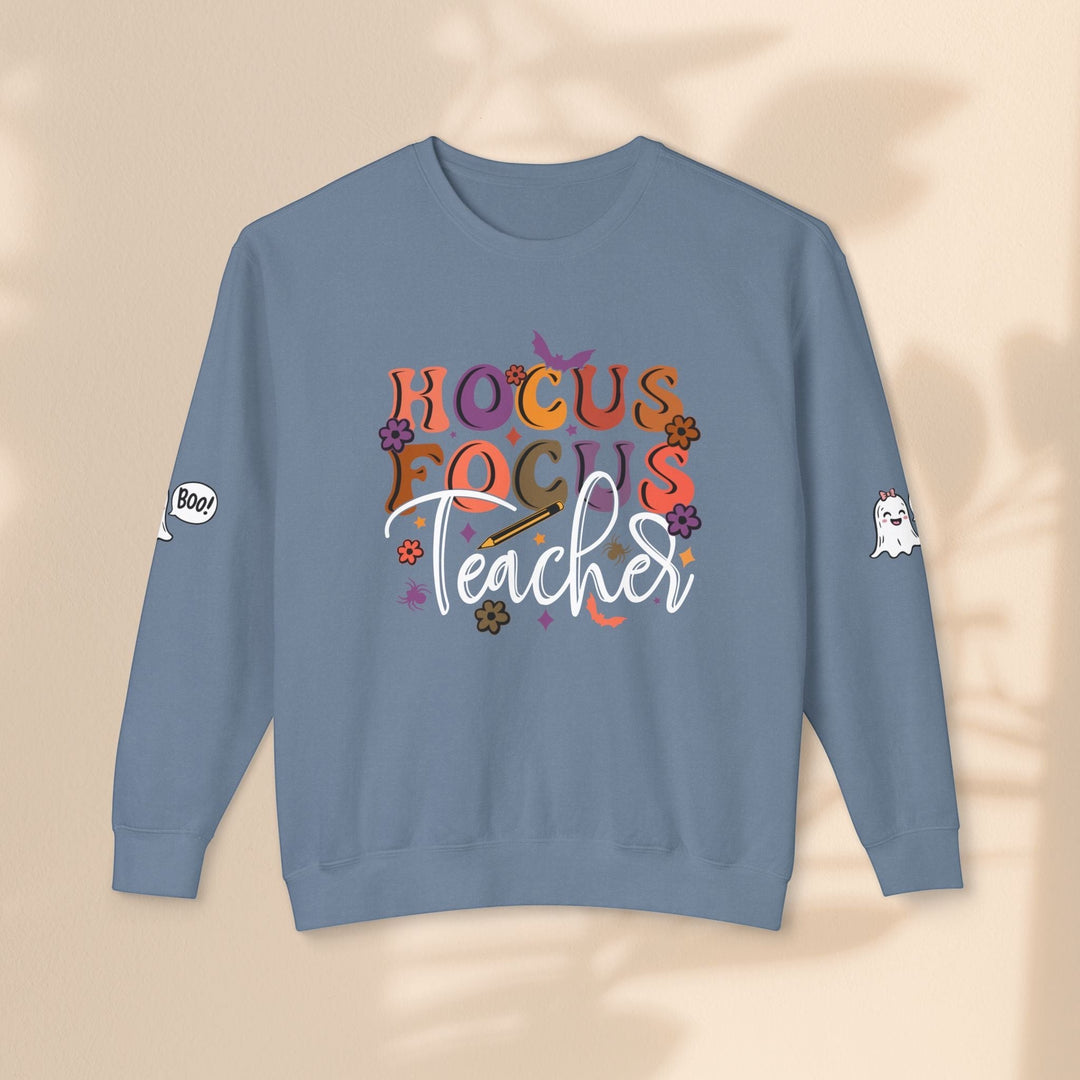 Sea Dragon Dreams blue crewneck sweatshirt with Hocus Focus Teacher graphic, ghost icons on sleeves, cotton fabric.