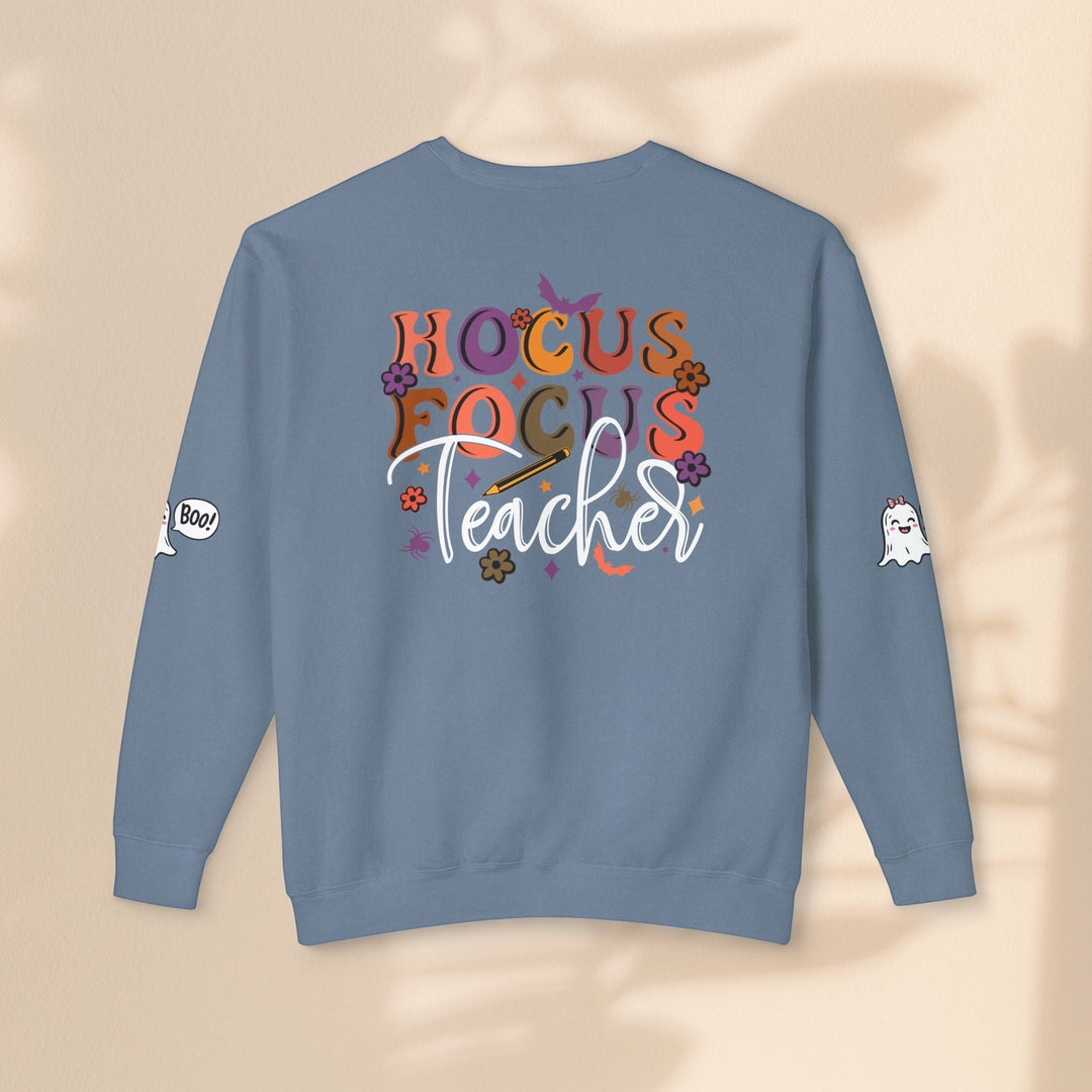 Sea Dragon Dreams blue crewneck sweatshirt with Hocus Focus Teacher graphic, ghost sleeve art, and relaxed fit.