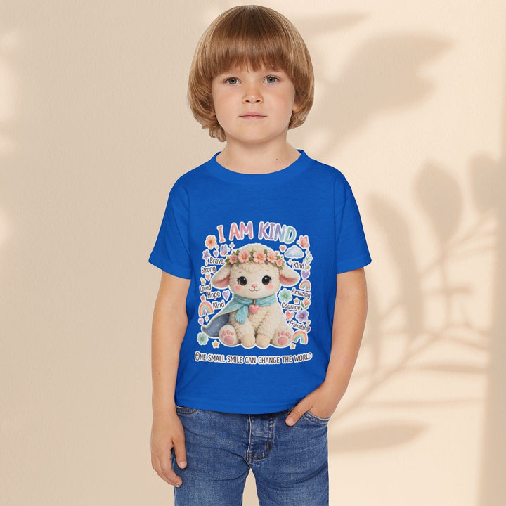 A child wearing a Sea Dragon Dreams blue cotton toddler t-shirt featuring a Grace Lamb graphic and I Am Kind text.