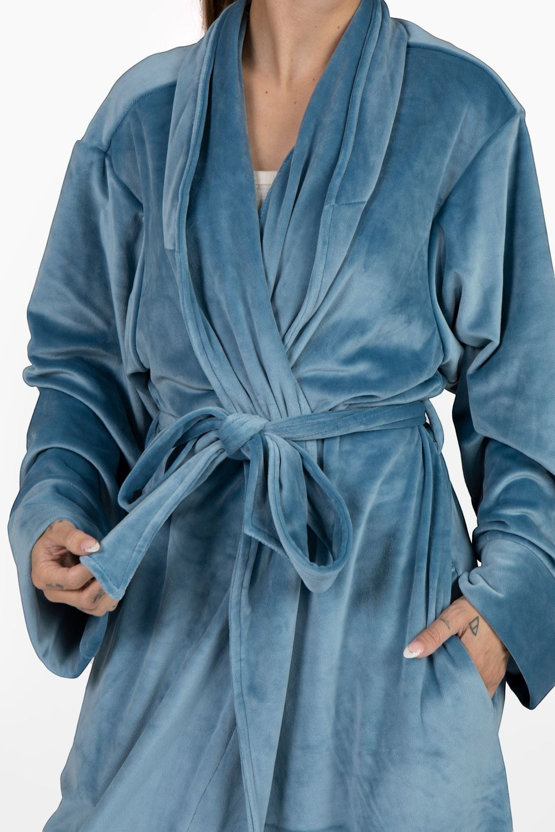 Sea Dragon Dreams plush blue velour robe with a tie waist and pockets, worn by a woman for cozy lounging.