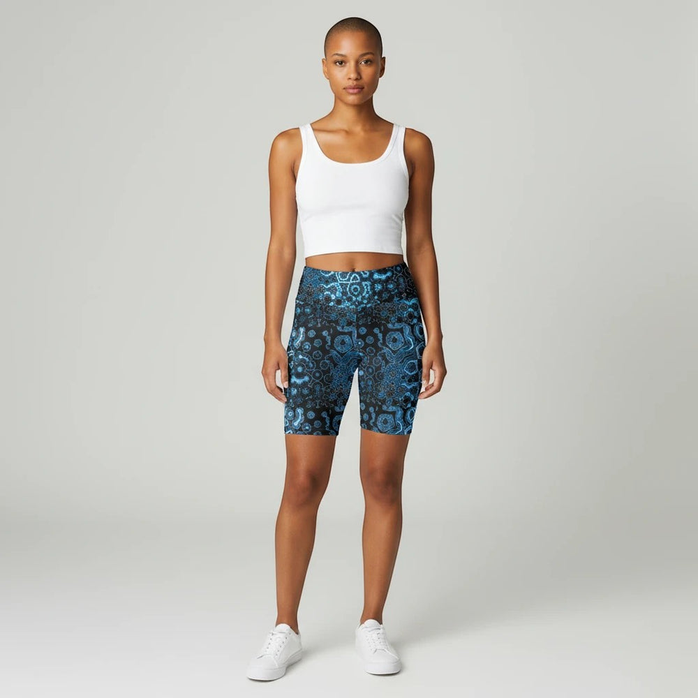Sea Dragon Dreams workout shorts in blue patterned polyester with a high-waist fit worn by a model in a white tank