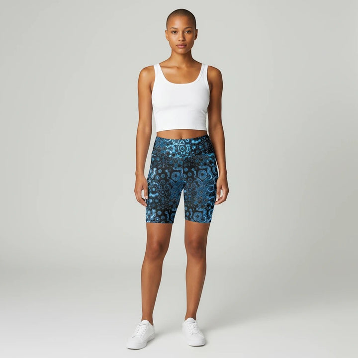 Sea Dragon Dreams workout shorts in blue patterned polyester with a high-waist fit worn by a model in a white tank
