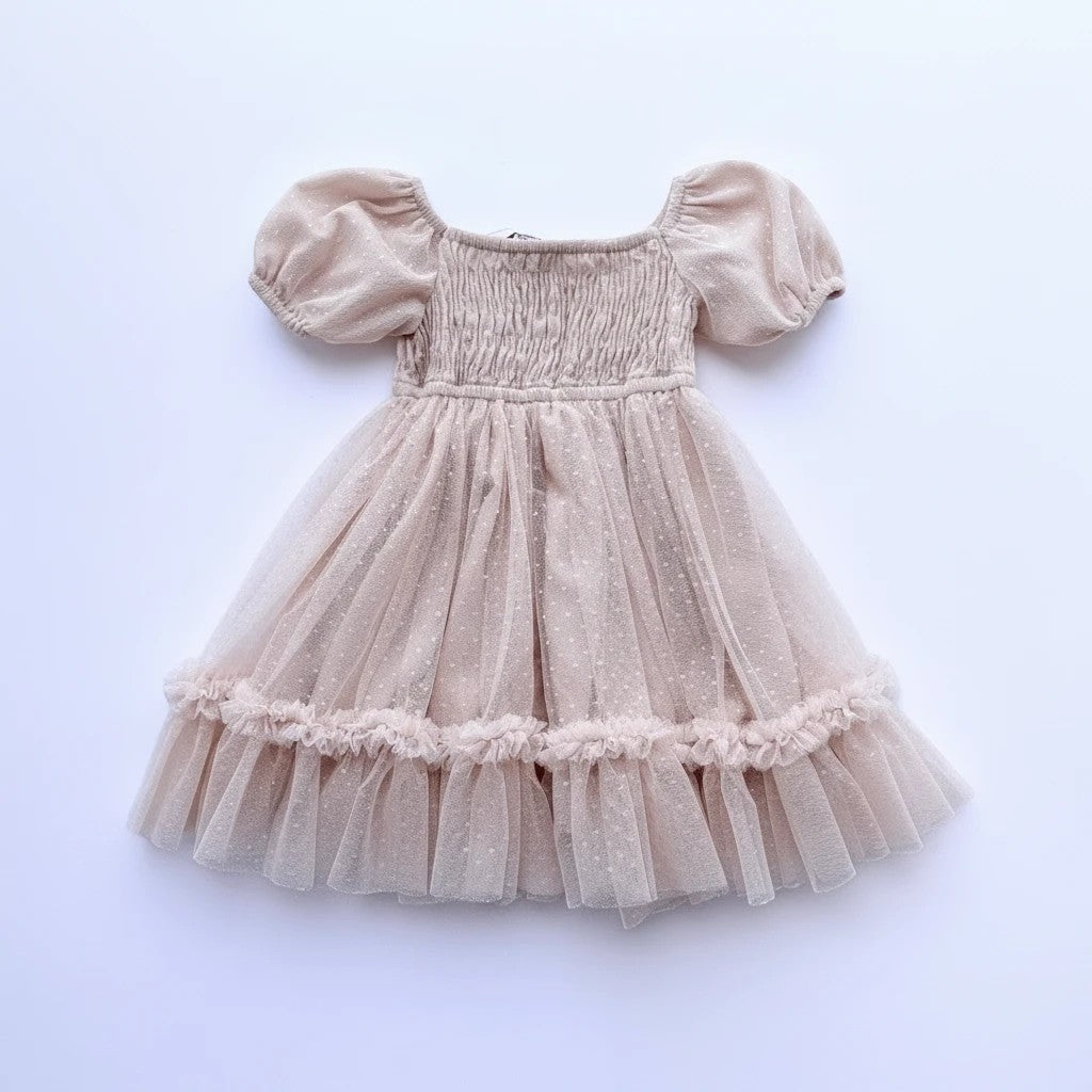 Sea Dragon Dreams toddler girl party dress in blush tulle with smocked bodice, puff sleeves, and ruffled hem.