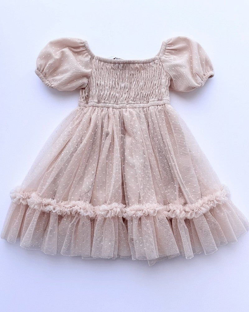 Sea Dragon Dreams toddler girl blush tulle party dress with smocked bodice, puff sleeves, and shimmering polka dots.