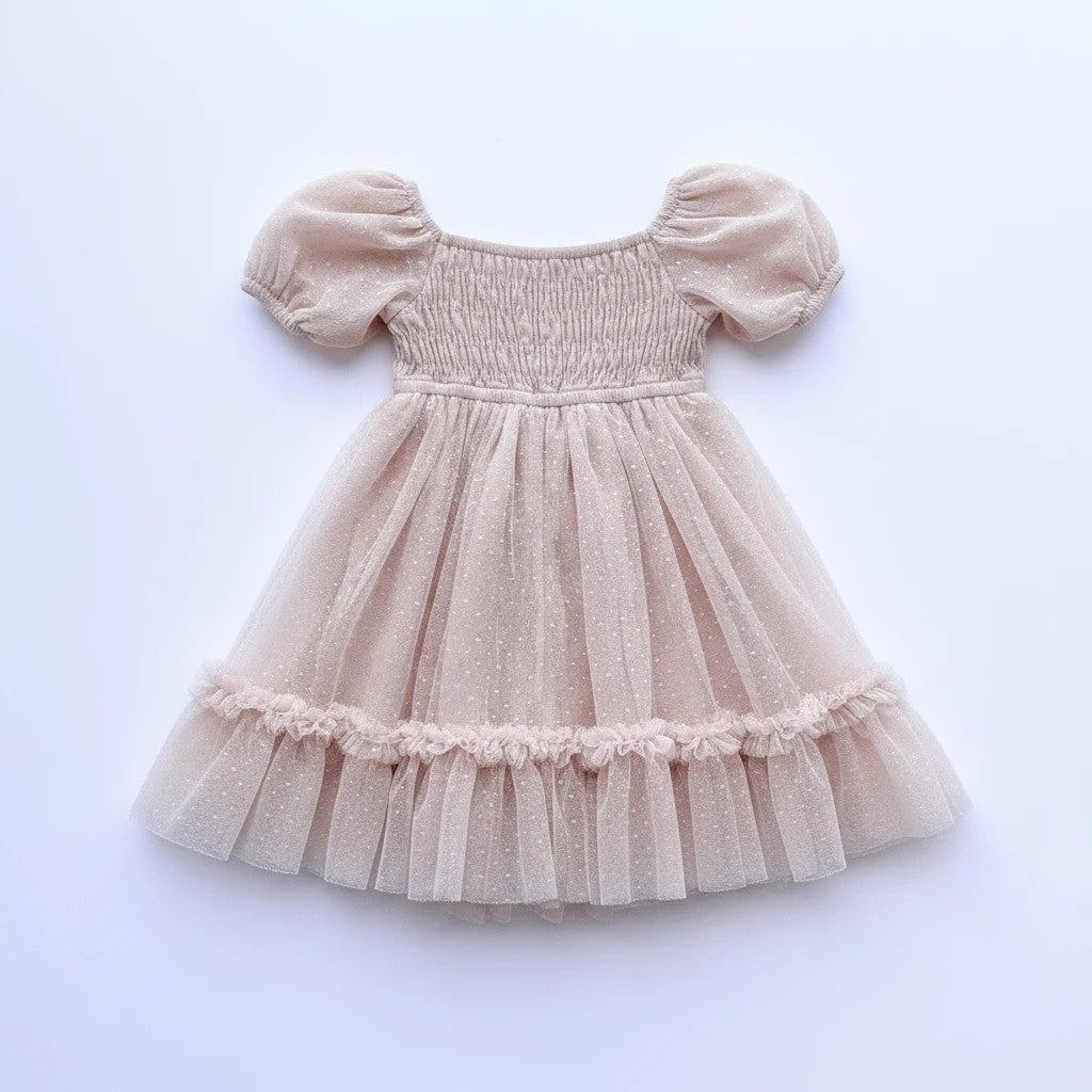 Sea Dragon Dreams toddler girl blush tulle party dress with smocked bodice, puff sleeves, and shimmering polka dots.