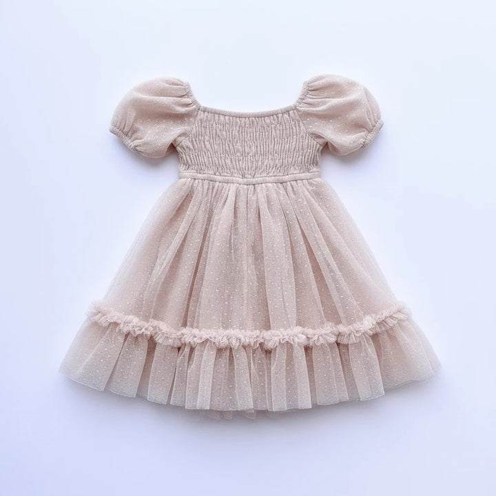 Sea Dragon Dreams toddler girl blush tulle party dress with smocked bodice, puff sleeves, and shimmering polka dots.