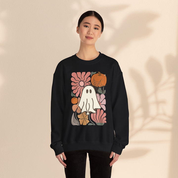 Sea Dragon Dreams black crewneck sweatshirt featuring a retro ghost, pumpkin, and floral graphic print on a model.