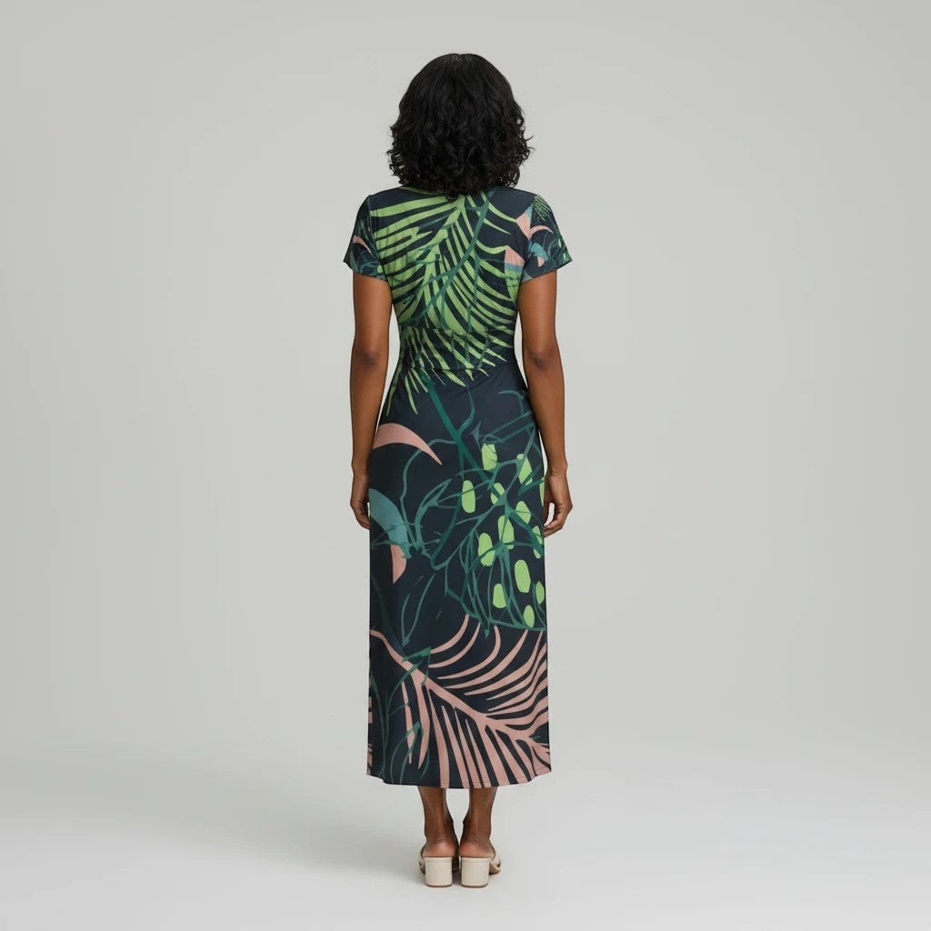 Back view of a Sea Dragon Dreams botanical print midi dress with flutter sleeves on a model against a grey background.