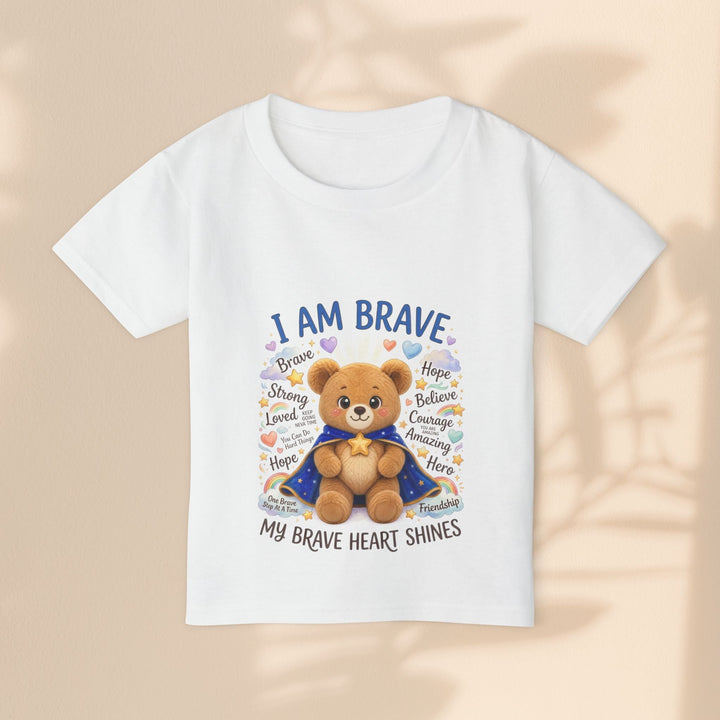 Sea Dragon Dreams white cotton toddler t-shirt featuring a cute teddy bear in a cape with the text I Am Brave