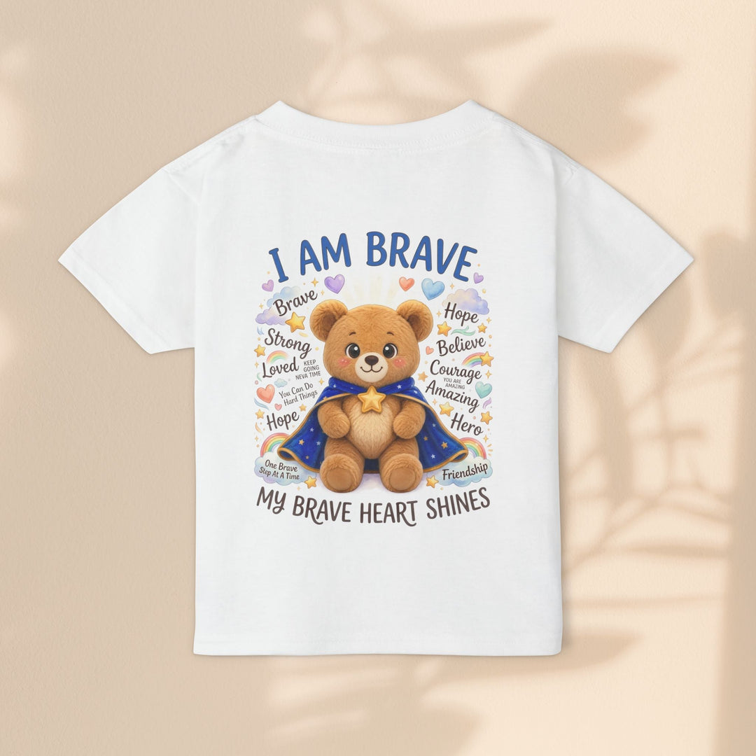 Sea Dragon Dreams white cotton toddler t-shirt featuring a cute teddy bear in a cape with I Am Brave text and rainbows.