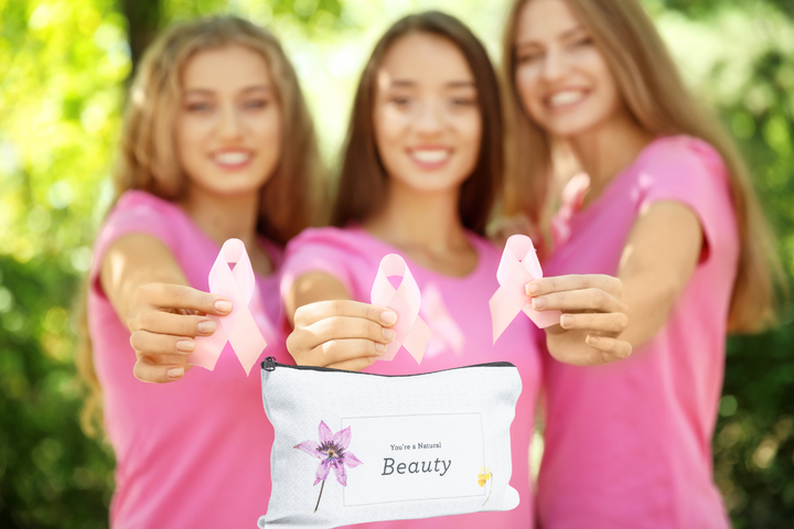 Sea Dragon Dreams breast cancer awareness gift set featuring pink ribbons and a floral cosmetic bag held by three women