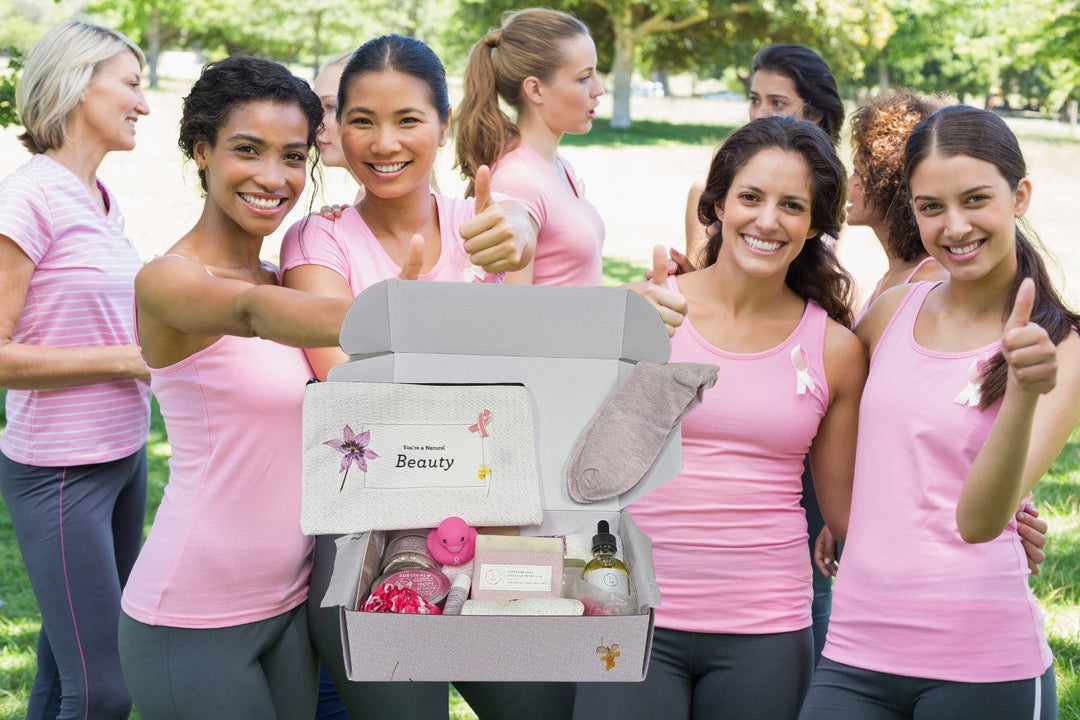 Sea Dragon Dreams breast cancer support gift box featuring natural spa items held by a group of women in pink shirts