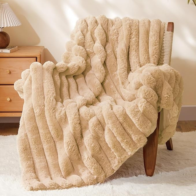 Sea Dragon Dreams BEDELITE brown faux rabbit fur throw blanket with 3D striped texture draped over a wooden chair.