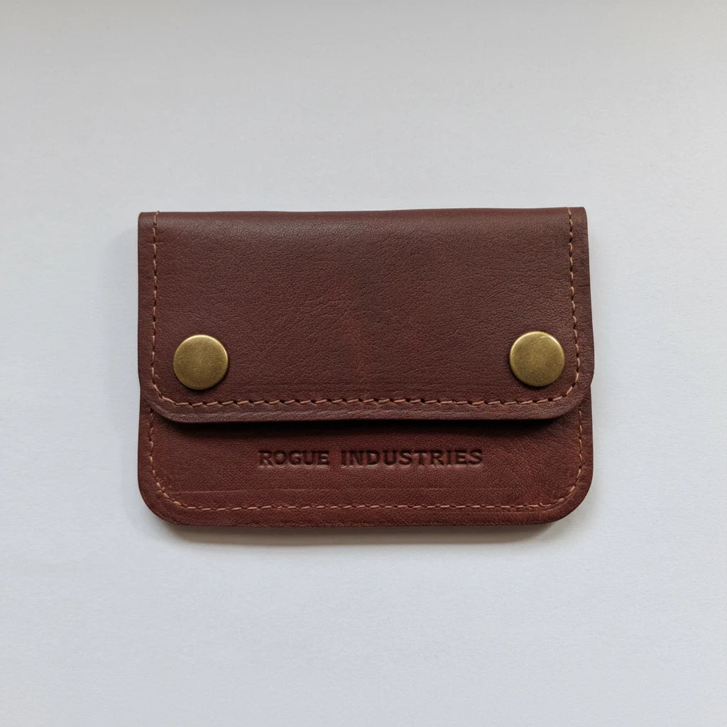 Sea Dragon Dreams Rogue full-grain leather belt wallet in brown with brass snap closures and minimalist design.