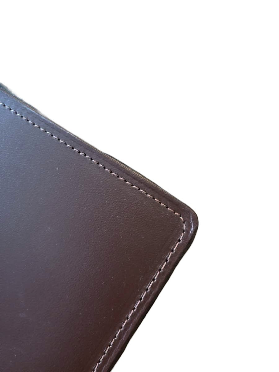 Sea Dragon Dreams brown top-grain leather desk pad corner with fine edge stitching and smooth finish.