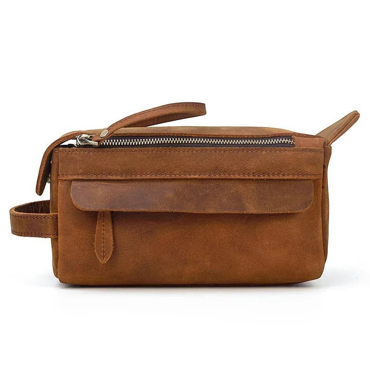 Sea Dragon Dreams handmade brown leather dopp kit with a front pocket, zipper closure, and side carry handle