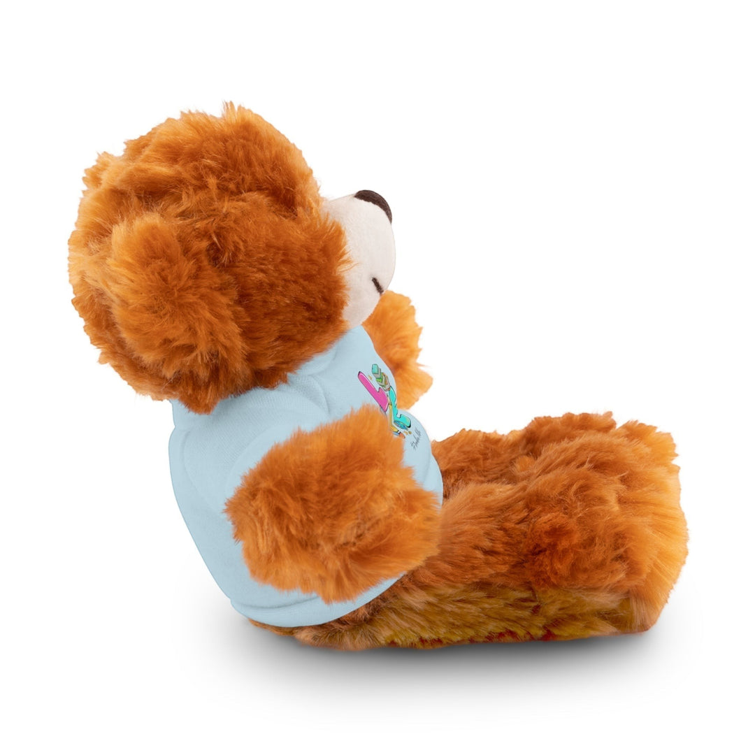 Sea Dragon Dreams brown plush teddy bear wearing a light blue t-shirt with Love Teacher Life graphic, side view.