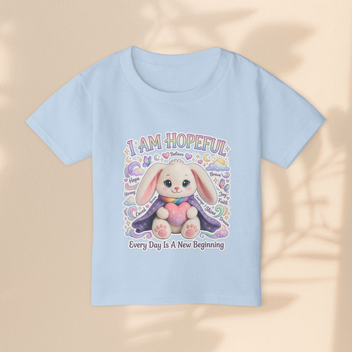 Sea Dragon Dreams light blue cotton toddler t-shirt featuring a cute bunny illustration and hopeful affirmations.