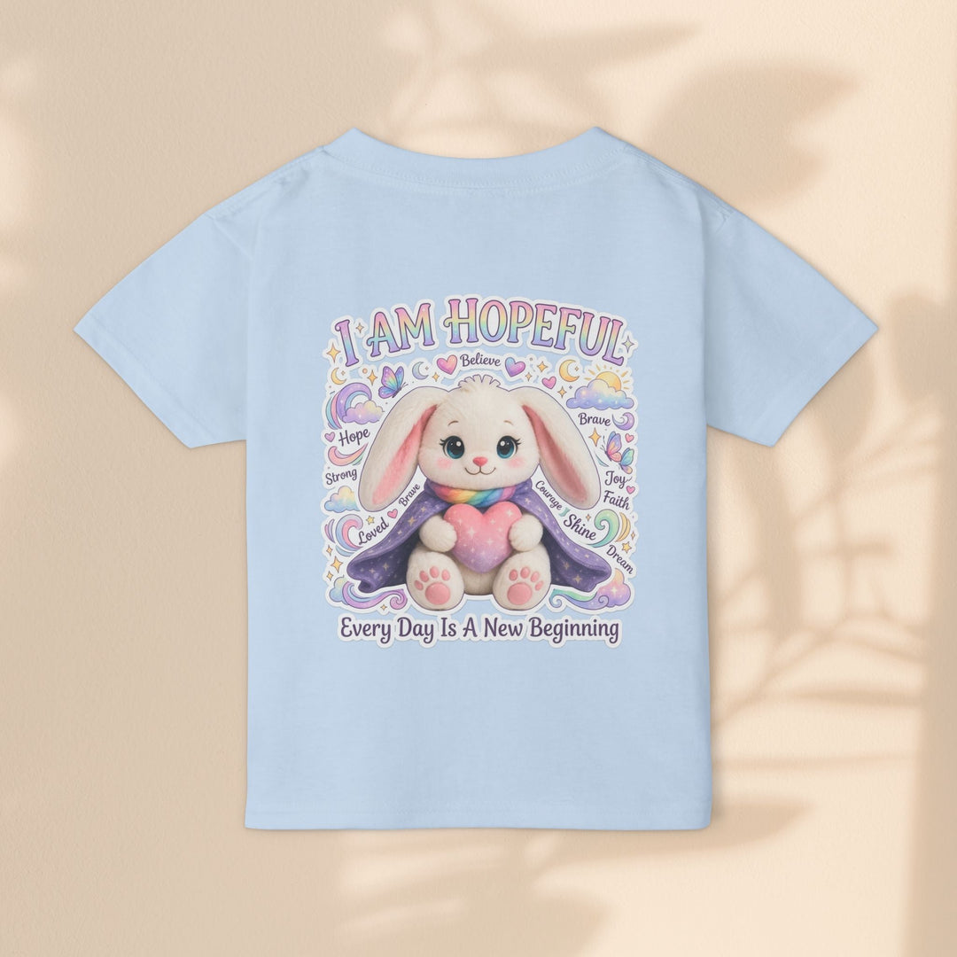 Sea Dragon Dreams light blue toddler t-shirt featuring a cute bunny holding a heart with hopeful affirmations.