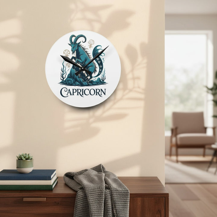 Sea Dragon Dreams round acrylic wall clock featuring a teal Capricorn sea-goat illustration hanging on a beige wall.