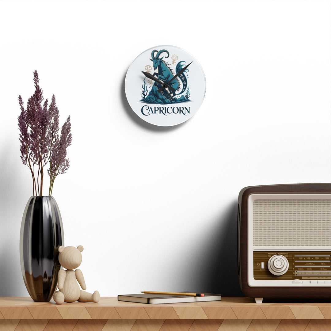 Sea Dragon Dreams round acrylic wall clock featuring a teal Capricorn sea-goat illustration hanging on a white wall.