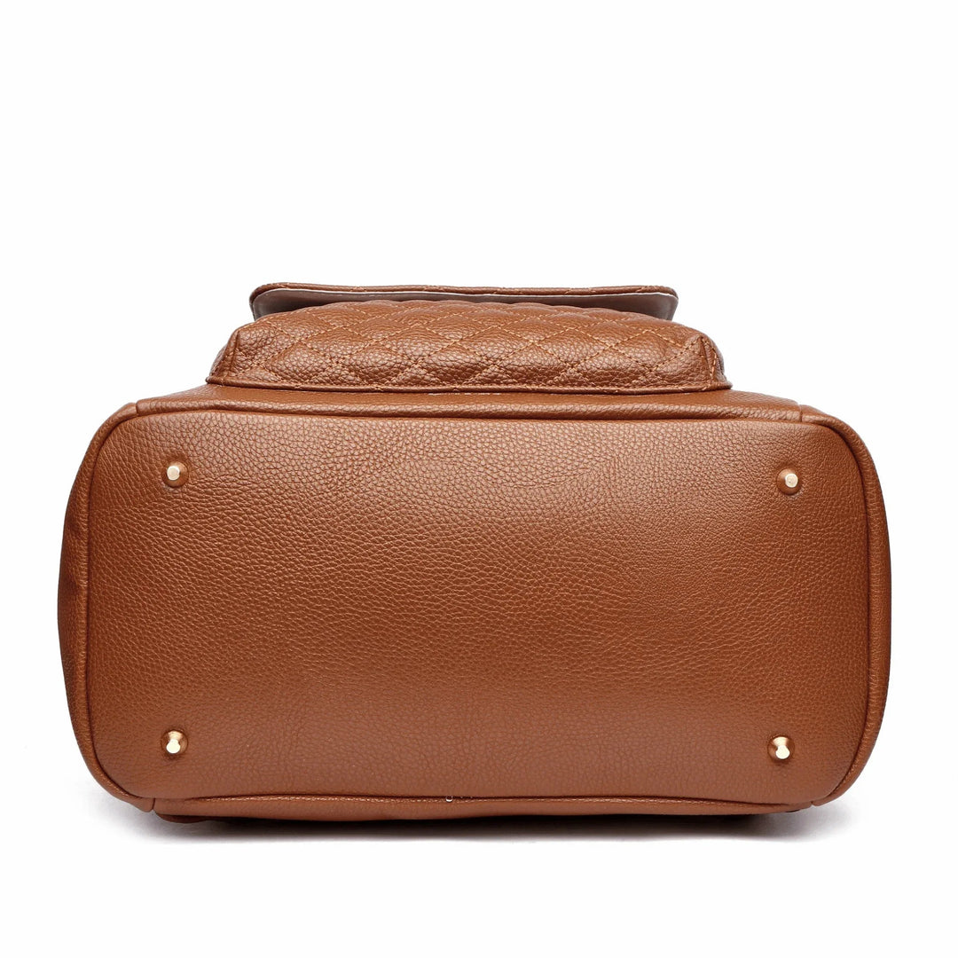 Sea Dragon Dreams caramel brown vegan leather diaper bag base with protective gold feet, showing quilted texture.